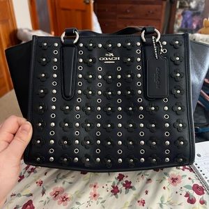 COPY - A dark blue coach hand bag with a over the shoulder strap